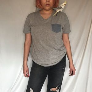 grey shirt with blue pocket